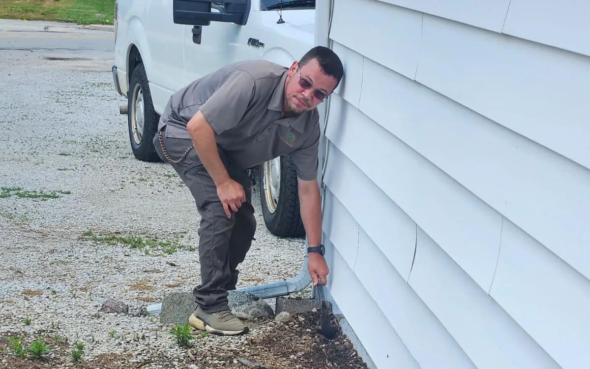 Uncled Ants technician inspecting the foundation of a home